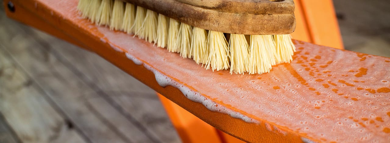 Orange Adiorndack Chair being cleaned
